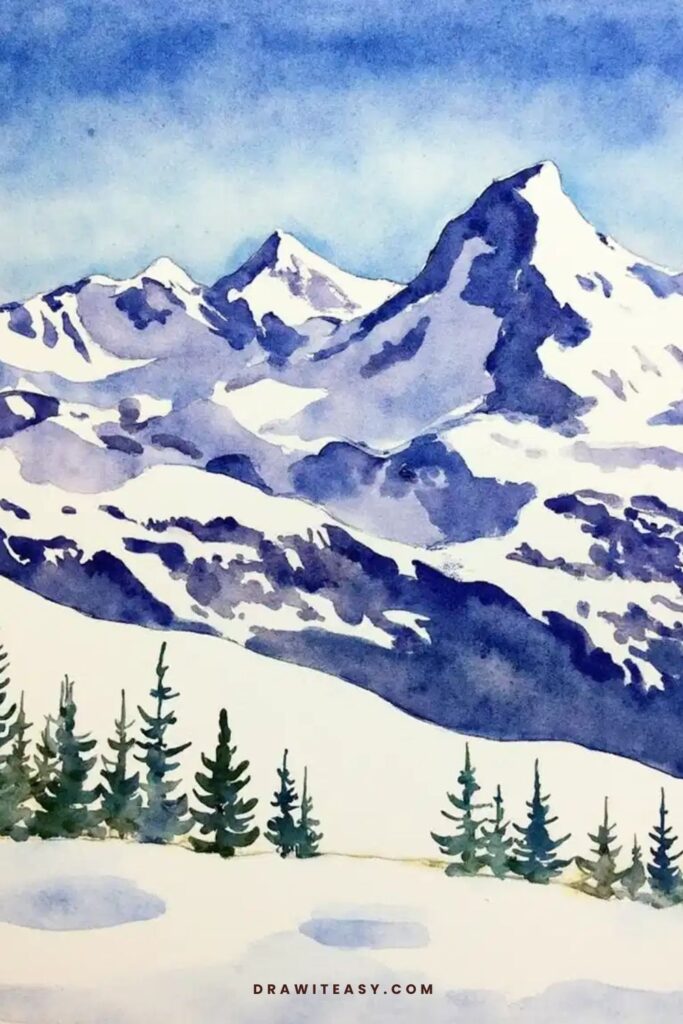 Snow-covered mountains under a bright blue sky